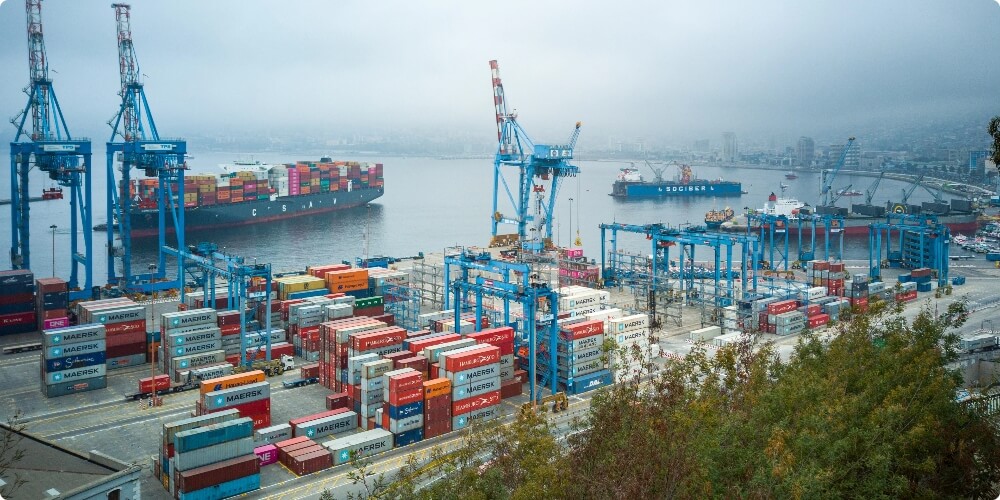 Image of a commercial port cargo ship loaded with containers Benefits of ERP system in supply chain management